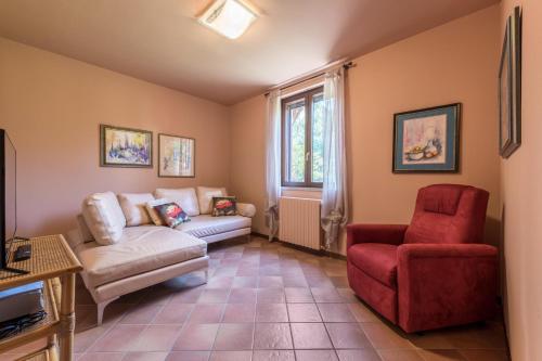 a living room with a couch and a chair at Casa Vacanze Matisse in Toscolano Maderno