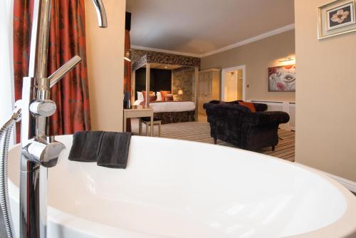 a bathroom with a sink and a living room at Burlington Hotel, BW Premier Collection by Best Western in Folkestone