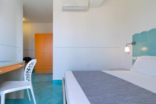 a bedroom with a bed and a desk and a chair at B&B Sperlonga in Sperlonga