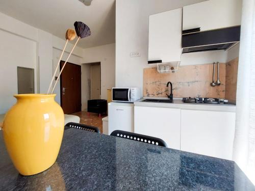 a yellow vase sitting on a table in a kitchen at Tiny house via mascilongo in Termoli