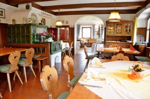 a dining room with a table and chairs at Seehotel Huber in Sankt Gilgen