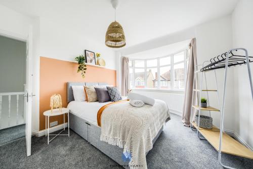 a bedroom with a bed and a window at Coventry Large Stylish 4 Bedroom House, Sleeps 8, Private Parking, by EMPOWER HOMES in Coventry