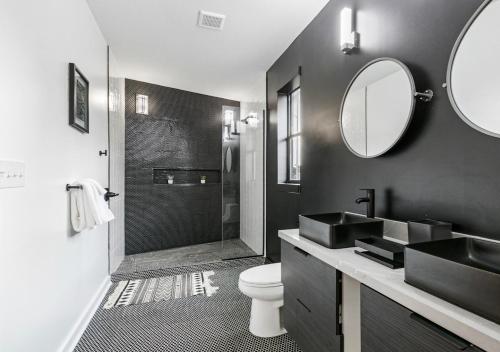 a bathroom with a sink and a toilet and a mirror at Galaxy Rooftop Villa in New Orleans