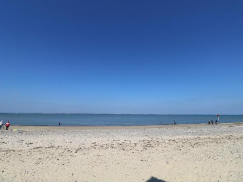 a group of people walking on the beach at Willow Cabin in Cowes