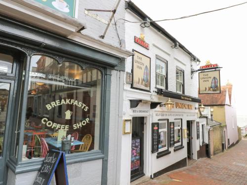 a row of shops on a city street at Willow Cabin in Cowes