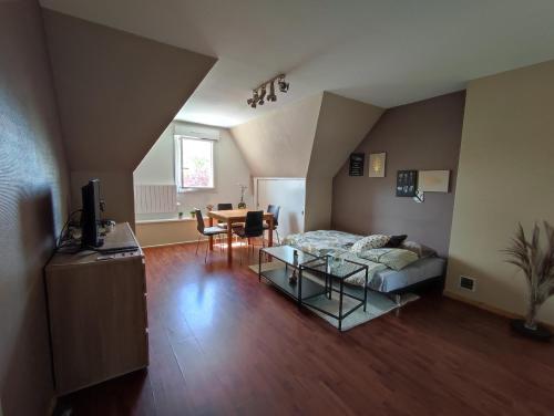 a living room with a couch and a table at Appartement calme aux portes de Rennes in Vezin-le-Coquet