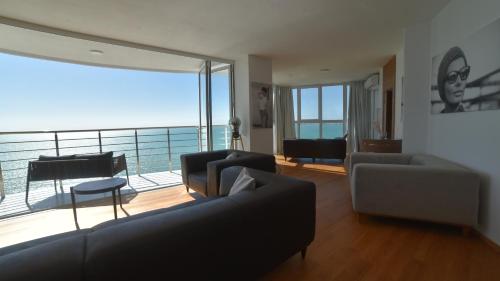 a living room with a view of the ocean at Beachfront Marilyn in Durrës