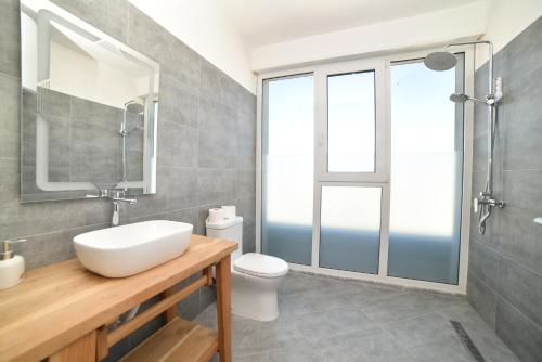 a bathroom with a sink and a toilet at Beachfront Marilyn in Durrës