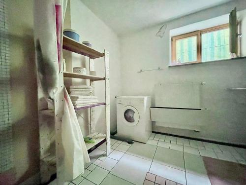 a bathroom with a white toilet in a room at VILLA mandala in Ankaran