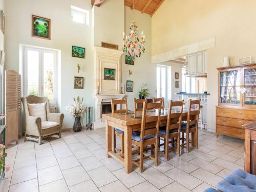 a kitchen and dining room with a table and chairs at Elegant Château Escape in Cézac