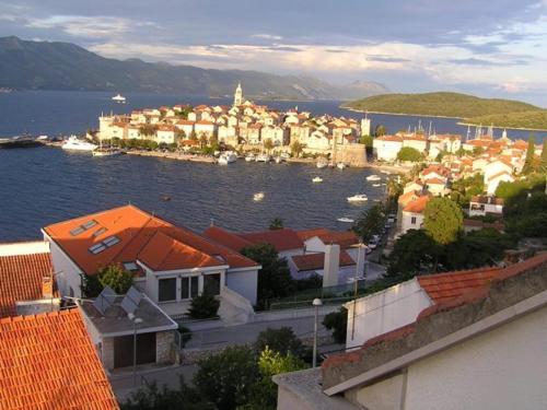 a city with a town and a body of water at Apartment Palma in Korčula