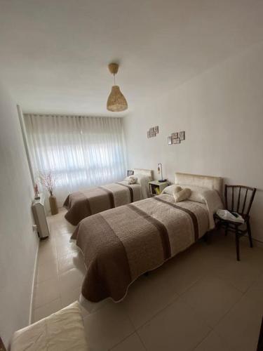 a row of beds in a room with a room with at -. Villa Nena .- in Ledesma