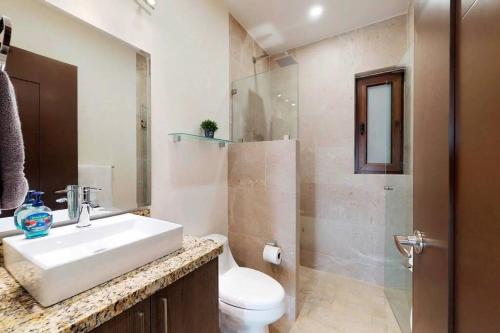 a bathroom with a sink and a toilet and a shower at Nayri Life 509 in Puerto Vallarta