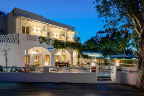 a large white house with lights on it at Hotel Eucalyptus in Mesaria