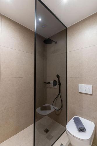 a bathroom with a shower with a toilet at Hotel Eucalyptus in Mesaria