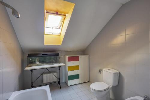 a bathroom with a toilet and a fish tank at Habitaciòn independiente con cama doble en dúplex in A Coruña
