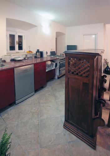 a large kitchen with a counter and appliances at House & Garden by the beach in Orebić