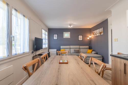 a living room with a wooden table and a couch at Ideally Located Furnished Townhouse With 3 Bedrooms Parking & Garden in Annecy