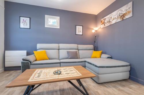 a living room with a couch and a table at Ideally Located Furnished Townhouse With 3 Bedrooms Parking & Garden in Annecy