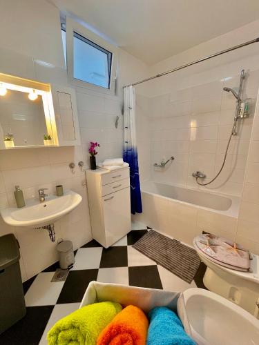 a bathroom with a sink and a tub and a toilet at Bonki apartment private free parking in Mokošica