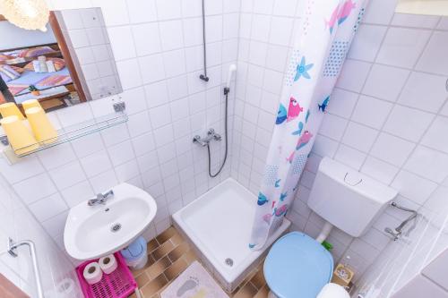 a bathroom with a sink and a toilet and a shower at RajkaAPP in Rab