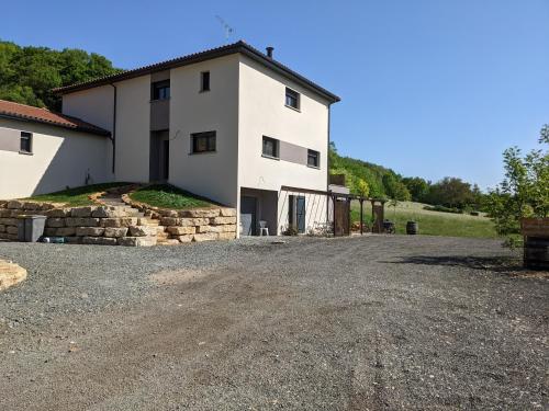 a large white house with a gravel driveway at Chambre double indépendante HARMONIE au sein du domaine PASSELOUP in Liergues