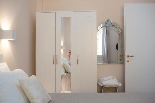 a bedroom with a bed and a mirror at Centrale Lefkada old town in Lefkada Town