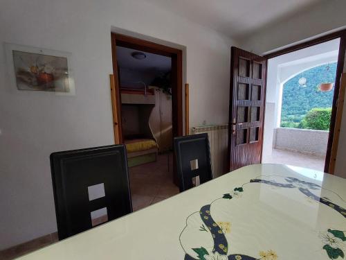 a dining room with a table and a window at Apartments Denis in Tolmin