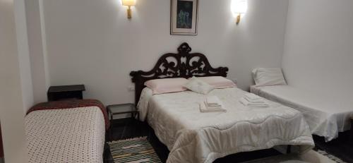 a bedroom with two beds and a chair at La Badia del Cavaliere 1 in Rome