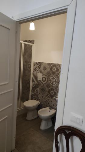 a bathroom with a toilet and a shower and a sink at La Badia del Cavaliere 1 in Rome
