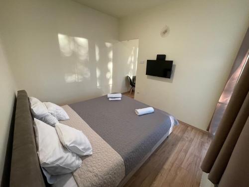 a bedroom with a bed with two towels on it at Park Central Tapolca - Apartments in Miskolctapolca
