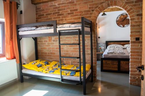 a room with bunk beds in a brick wall at Ecitlav - ubytování Valtice in Valtice