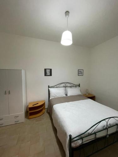 a bedroom with a large bed and a light at Casa Vacanze Linuccio in Casalabate