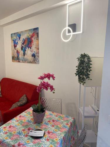 a living room with a table and a red couch at Franz home Wi-Fi AC 1 free parking in Bolzano