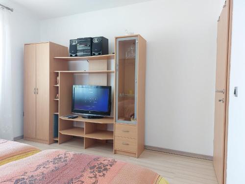 a bedroom with a desk with a computer in a book shelf at Apartments Denis in Tolmin