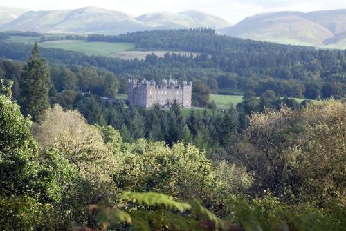 a castle in the middle of a forest of trees at Garden Studio in Biggar in Biggar