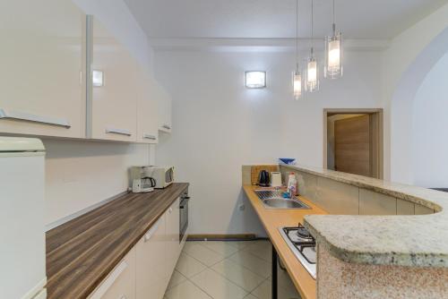 a kitchen with white cabinets and a counter top at Dora Apartment-Adults Only in Senj