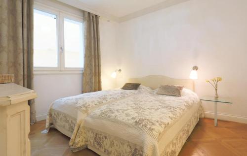 a white bedroom with a bed and a window at SUNSET with view in Seborga in Seborga