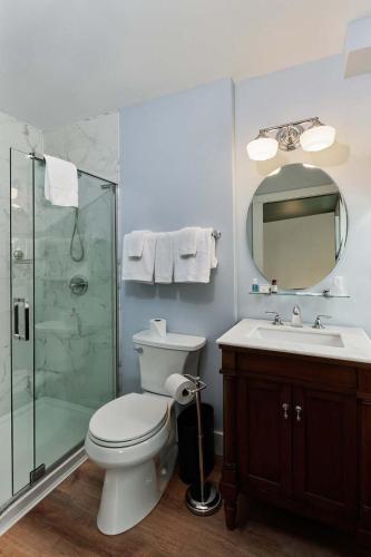 a bathroom with a toilet and a shower and a sink at The Whitlock by The Lenox Collection in Lenox