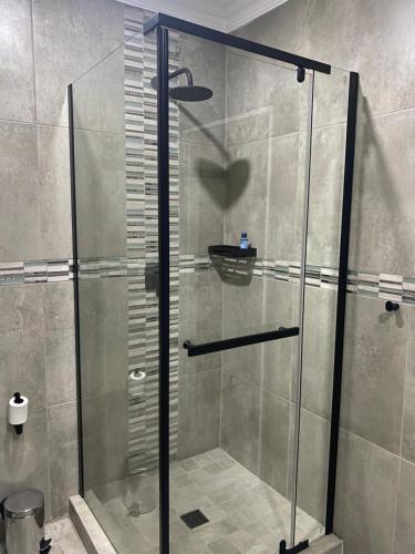 a shower with a glass door in a bathroom at The One Kathu in Kathu