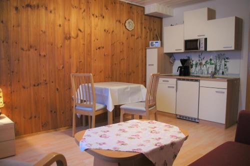 a kitchen with a table and two chairs and a table and a table at Ferienwohnung Hofmann in Bad Kreuznach