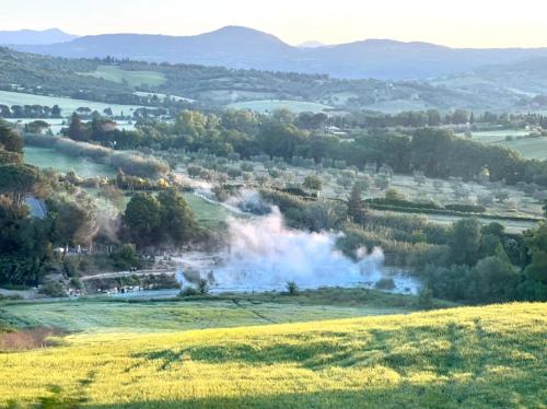 a fire in a field with smoke coming out at Agriturismo Bio Pian Dei Casali in Saturnia