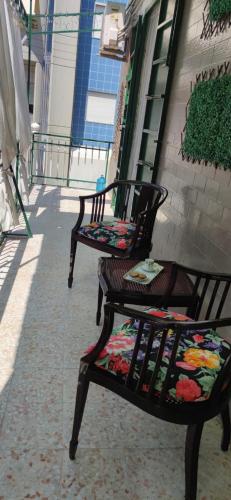 two chairs sitting on a sidewalk next to a building at Sister House in Cerignola