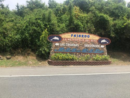 a sign for ahibro sign on the side of the road at Marina Lanais Condominio in Las Croabas