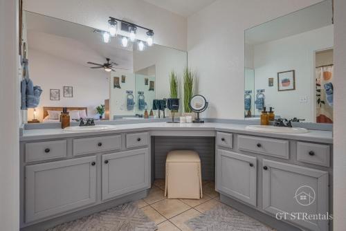 a bathroom with two sinks and a large mirror at FRESHWATER FUN - Pet & Family Friendly with Great Location! in Bullhead City
