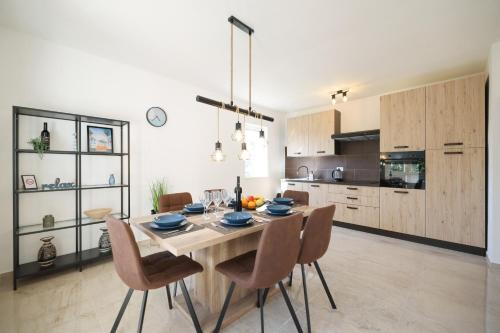 a kitchen with a dining room table and chairs at Holiday house Antulov in Vodice