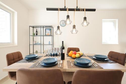 a dining room with a table with blue plates and chairs at Holiday house Antulov in Vodice