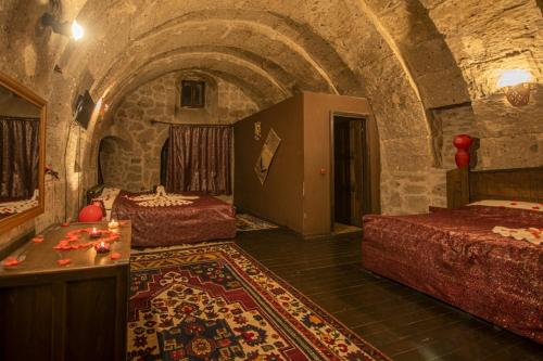 Postel nebo postele na pokoji v ubytování Kapadokya Ihlara Konakları Otel Antik Konaklar