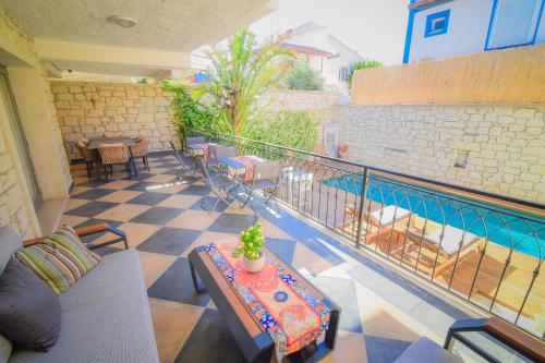 a balcony with a table and a swimming pool at 9 Alacati Boutique Hotel in Alacati