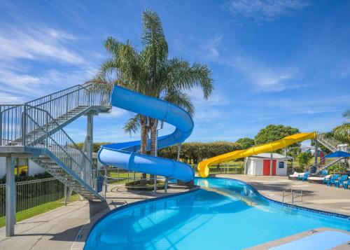 a water slide in a park with a swimming pool at Ohope Beach TOP 10 Holiday Park in Ohope Beach